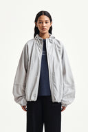 BACK LOGO HOODY WIND BREAKER IN LIGHT BEIGE