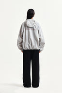 BACK LOGO HOODY WIND BREAKER IN LIGHT BEIGE