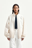 BACK LOGO HIGH NECK JUMPER IN CREAM