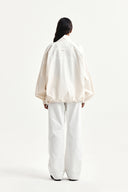 BACK LOGO HIGH NECK JUMPER IN CREAM