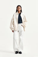 BACK LOGO HIGH NECK JUMPER IN CREAM